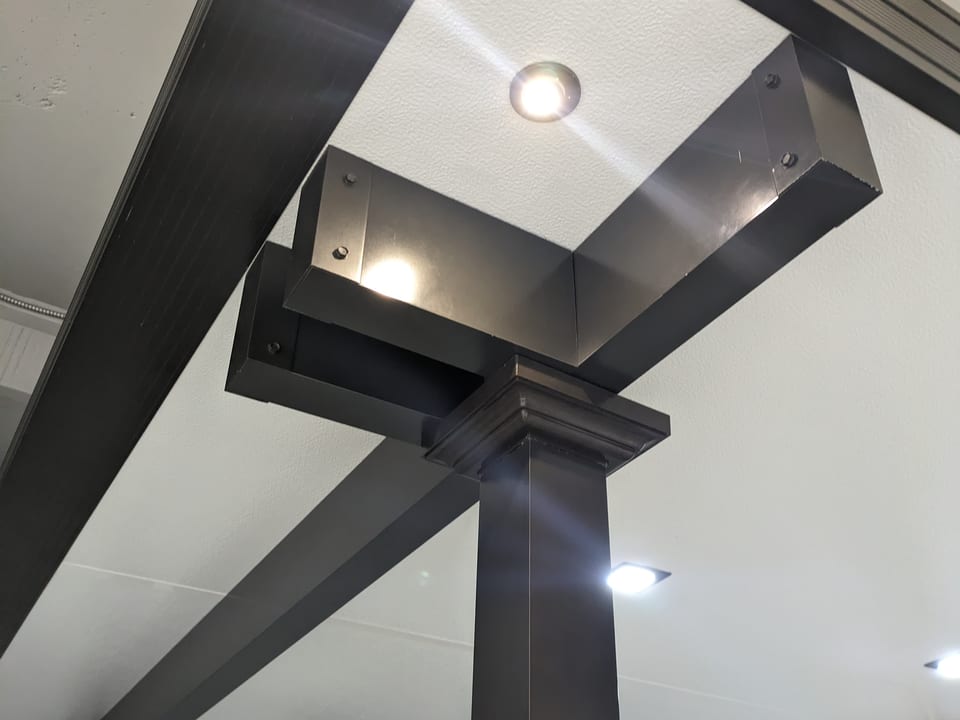 Insulated patio roof in bronze color, L-shaped structure